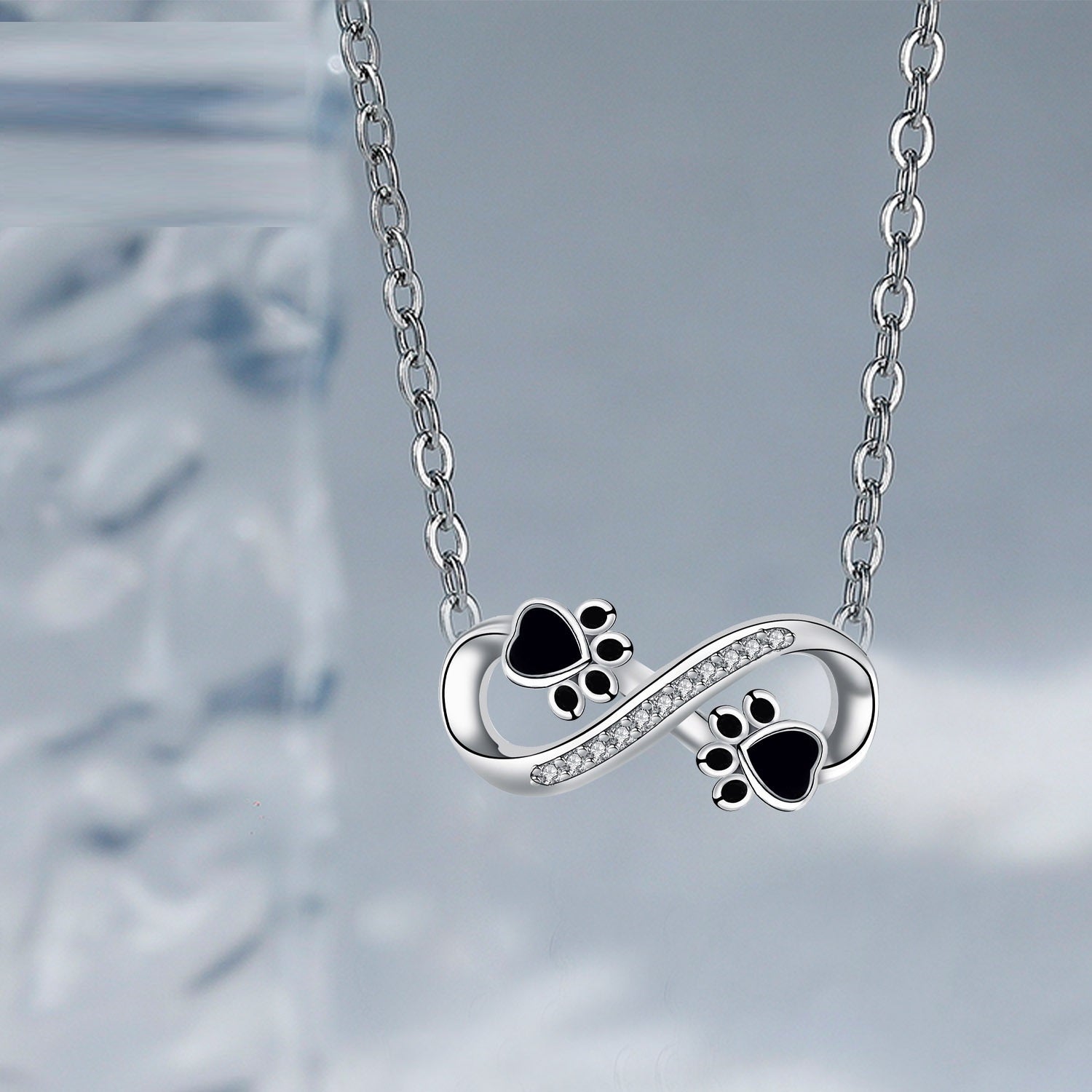 Collar Infinity con huella de pata y zirconias